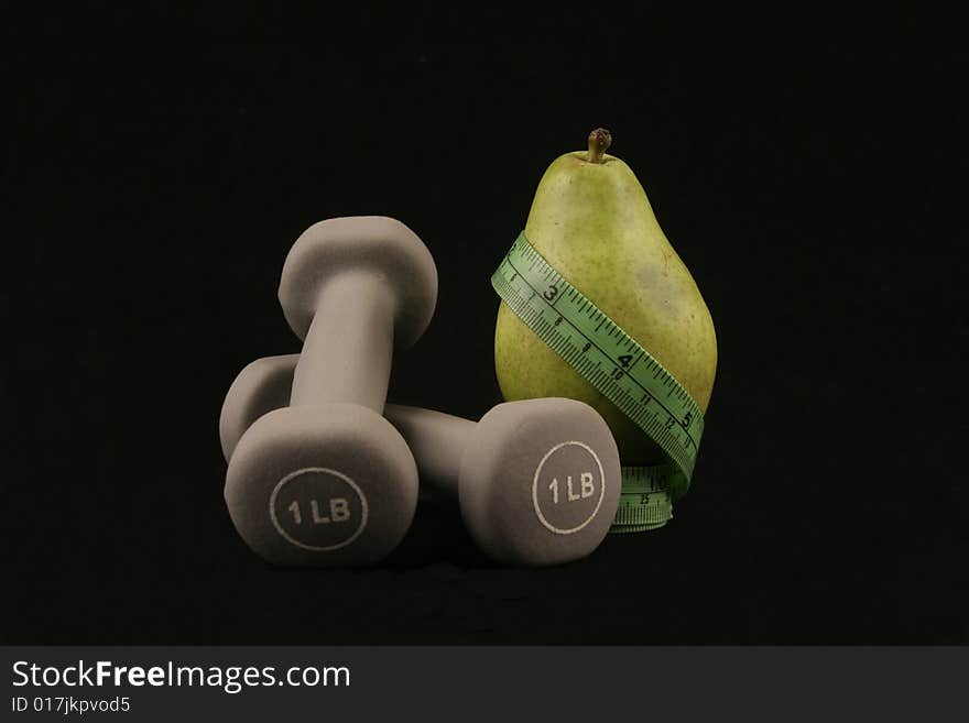 Photo of a pear and wieghts. Photo of a pear and wieghts