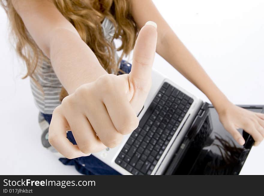 Girl with laptop showing her thumb on  an isolated white background