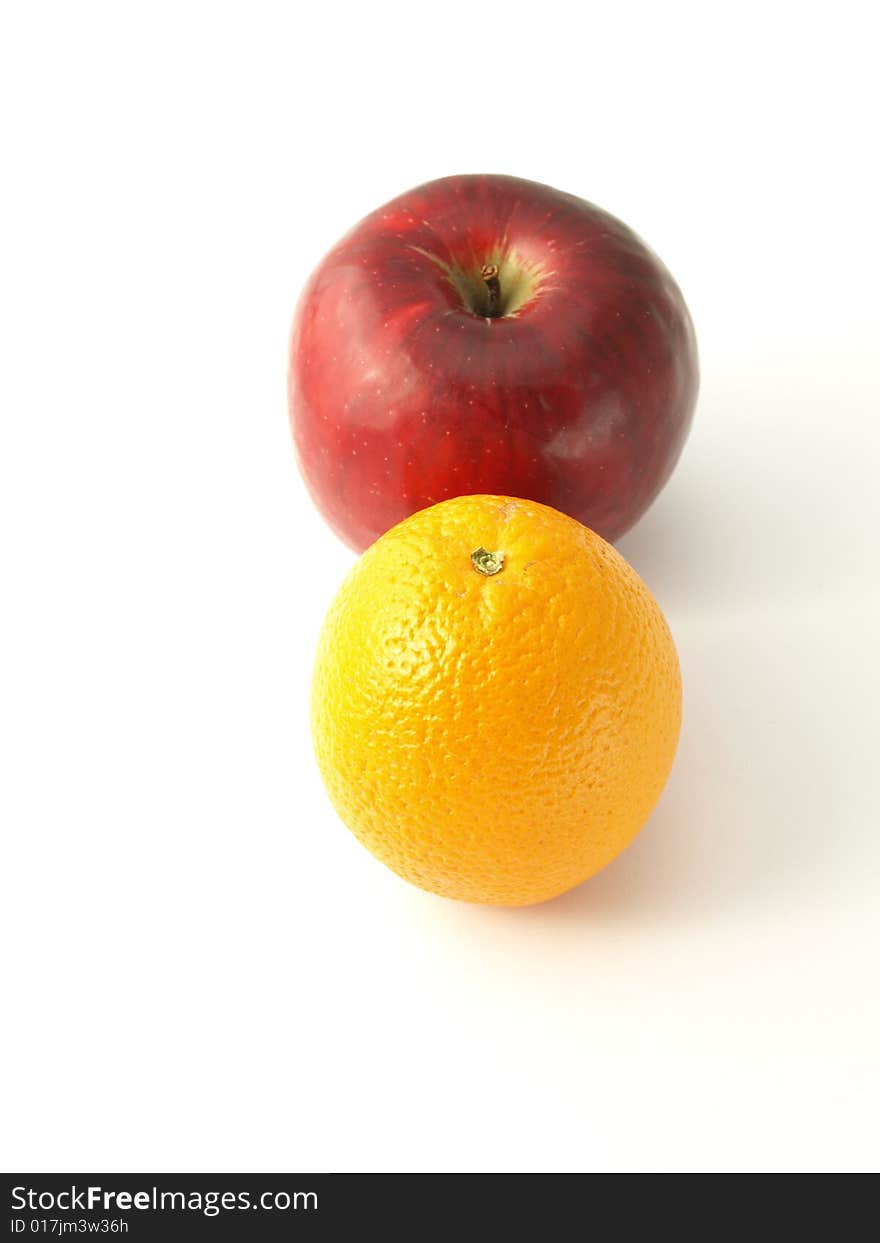 Orange and apple on white isolated background. Orange and apple on white isolated background.