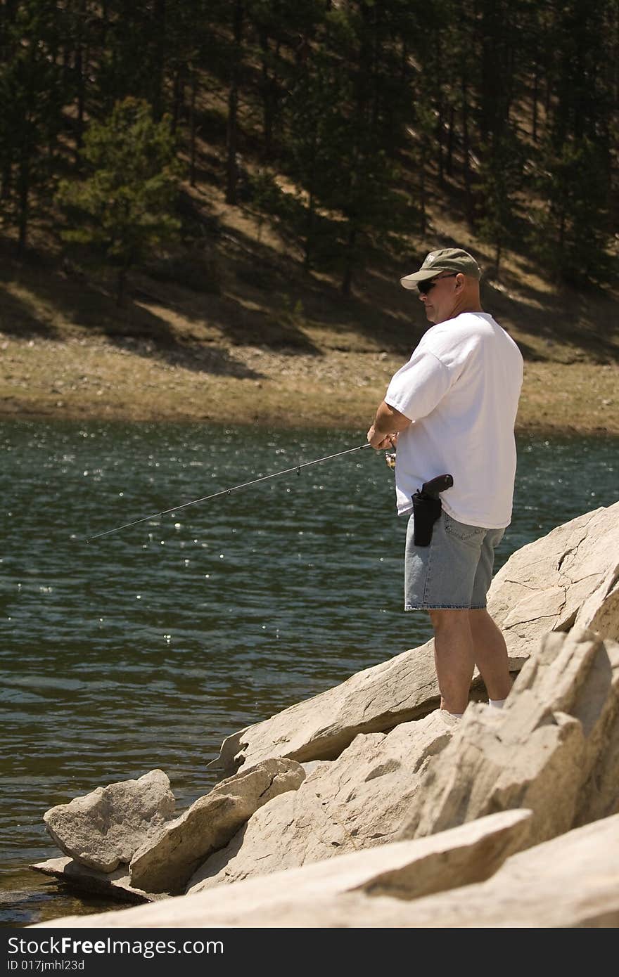 Man Fishing in Rocks