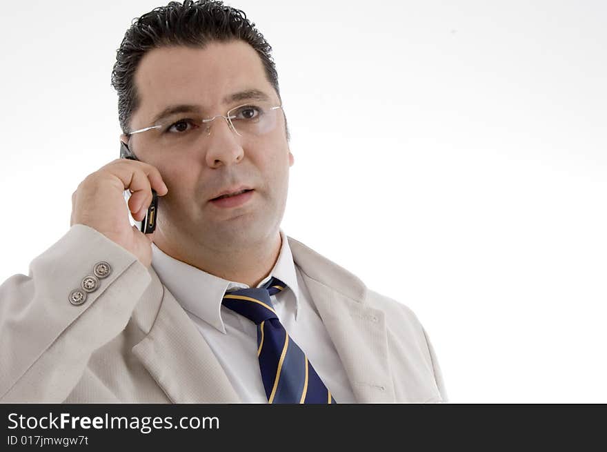 Portrait of businessman talking on cell phone on  an isolated white background