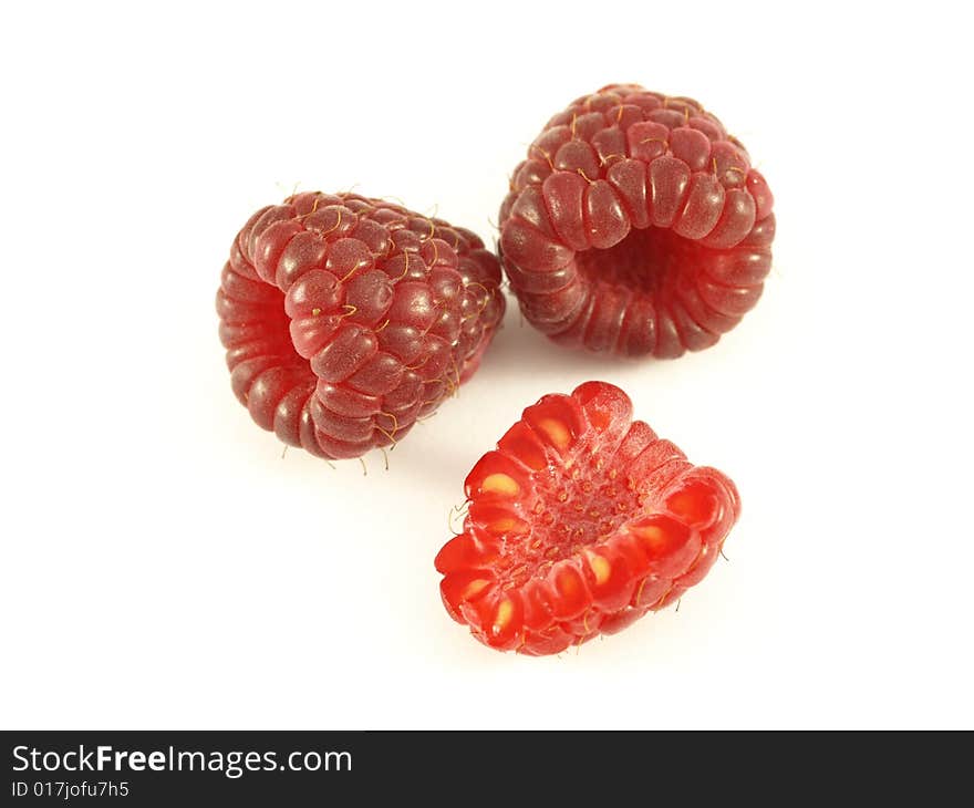 Raspberries on isolated white background with one in front.