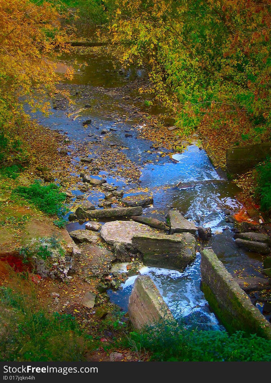 Beautiful multi-layered waterfall in the autumn park. Beautiful multi-layered waterfall in the autumn park