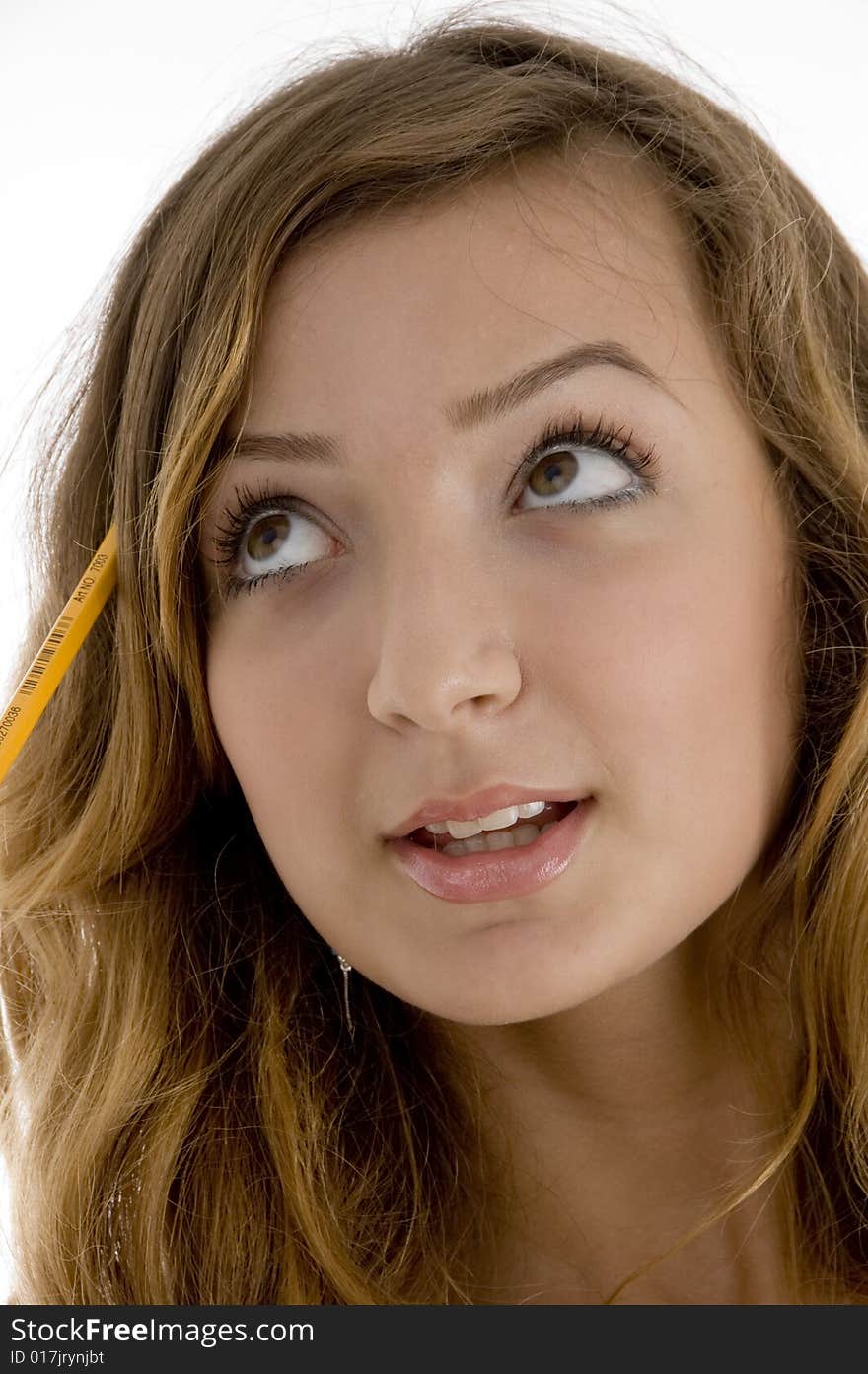 Close up of school girl with a pencil in her hair on  an isolated white background