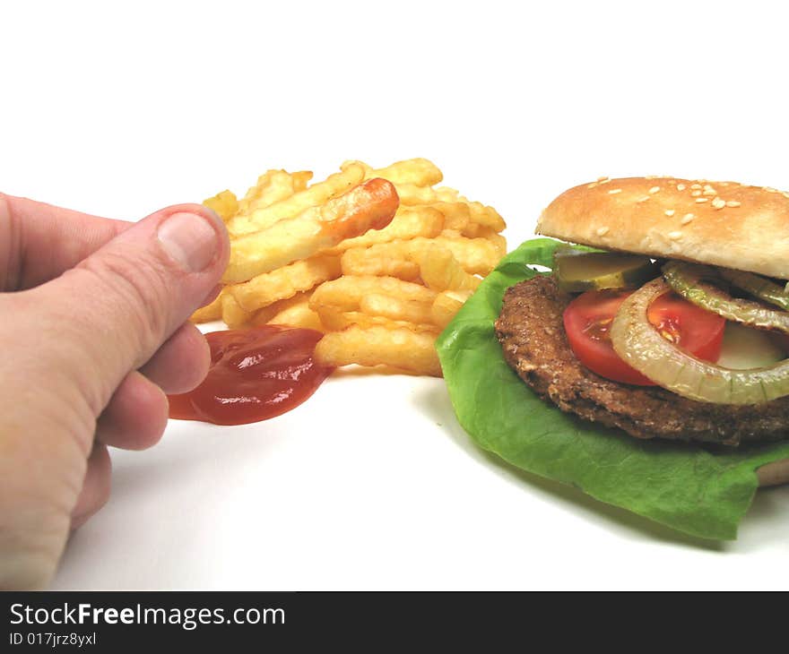 A man eating eating fries and a hamburger. A man eating eating fries and a hamburger