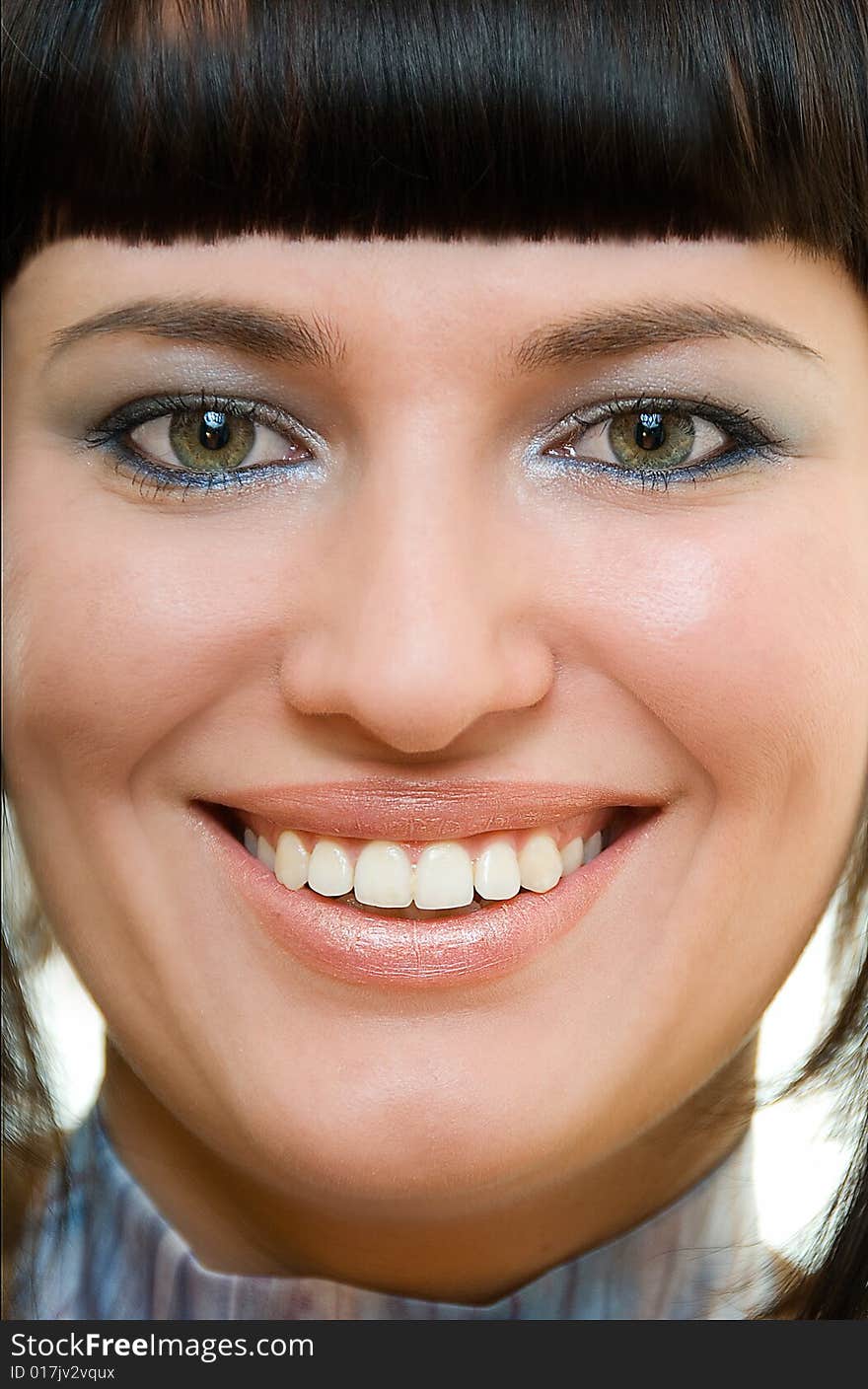 Portrait of pretty smiling brunette with composition accent on eyes and teeth. Portrait of pretty smiling brunette with composition accent on eyes and teeth