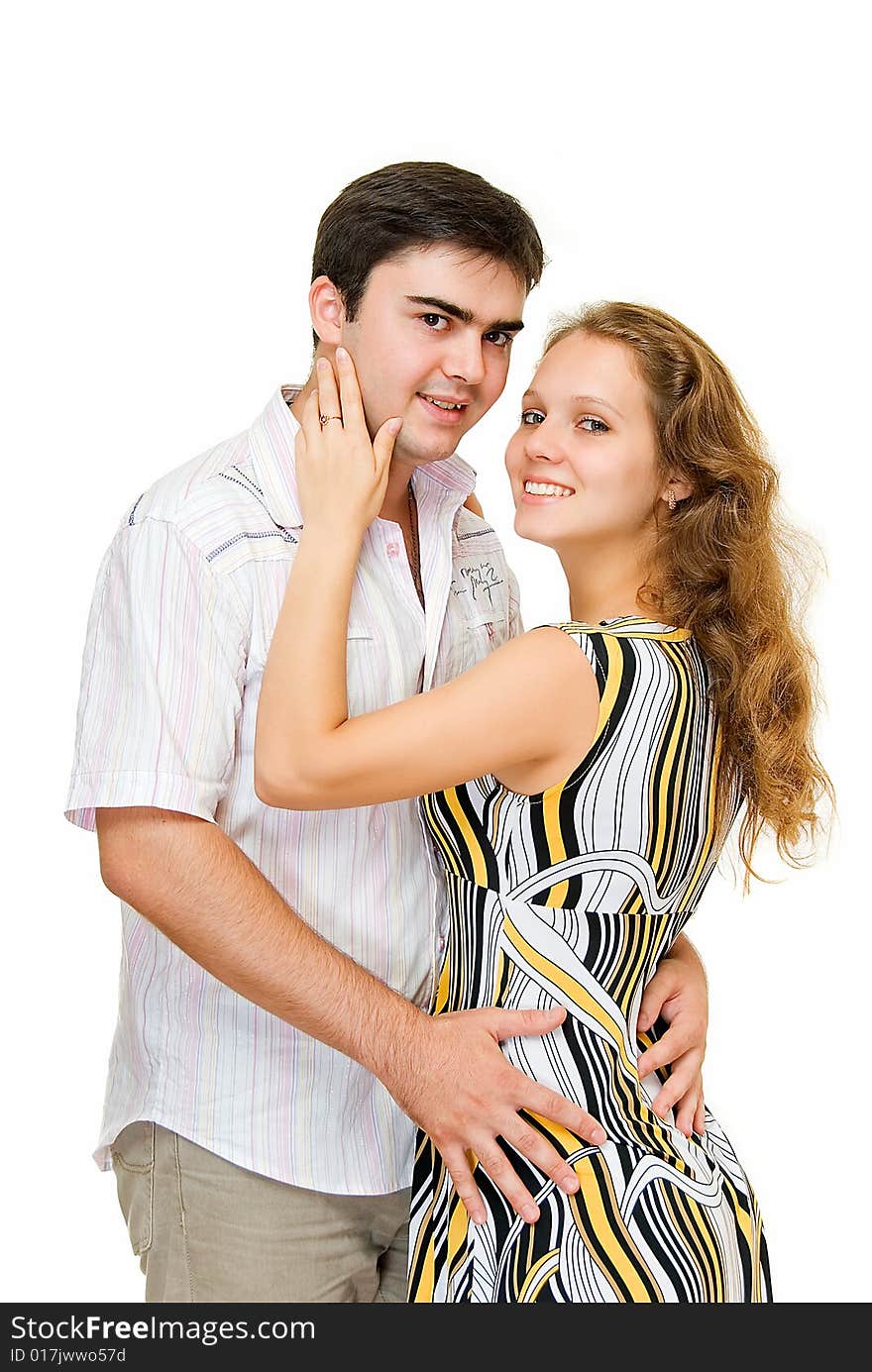 Young smiling and embracing couple on white