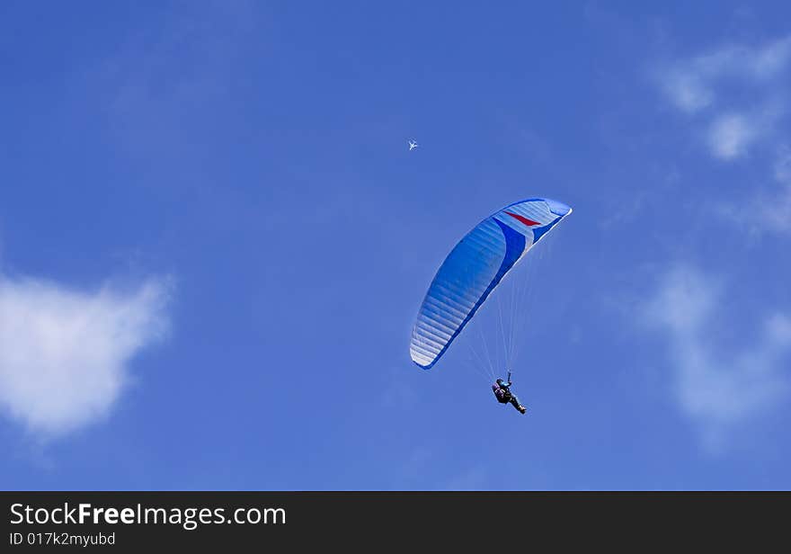 Paragliding and jet in the air