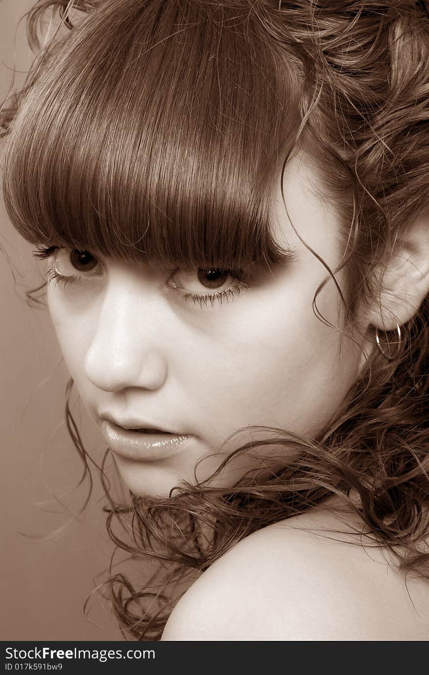 Nice girl with curly hair and penetrating glance over red background (Sepia). Nice girl with curly hair and penetrating glance over red background (Sepia)