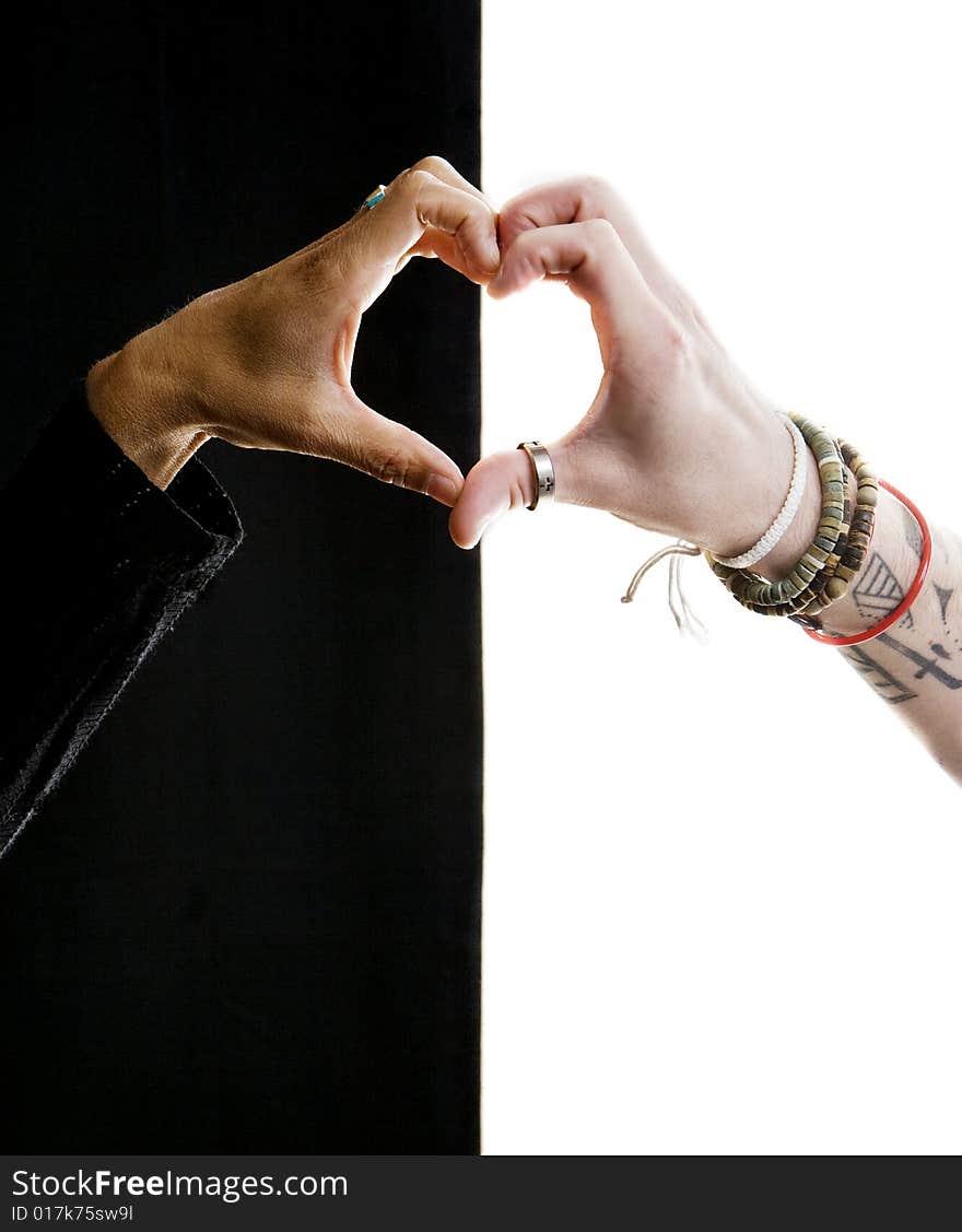 Close up of black and white hands making a heart. Close up of black and white hands making a heart