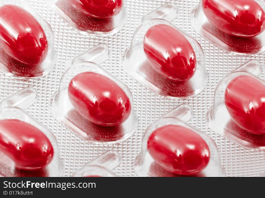 Red oval medical pills in their packages. Red oval medical pills in their packages