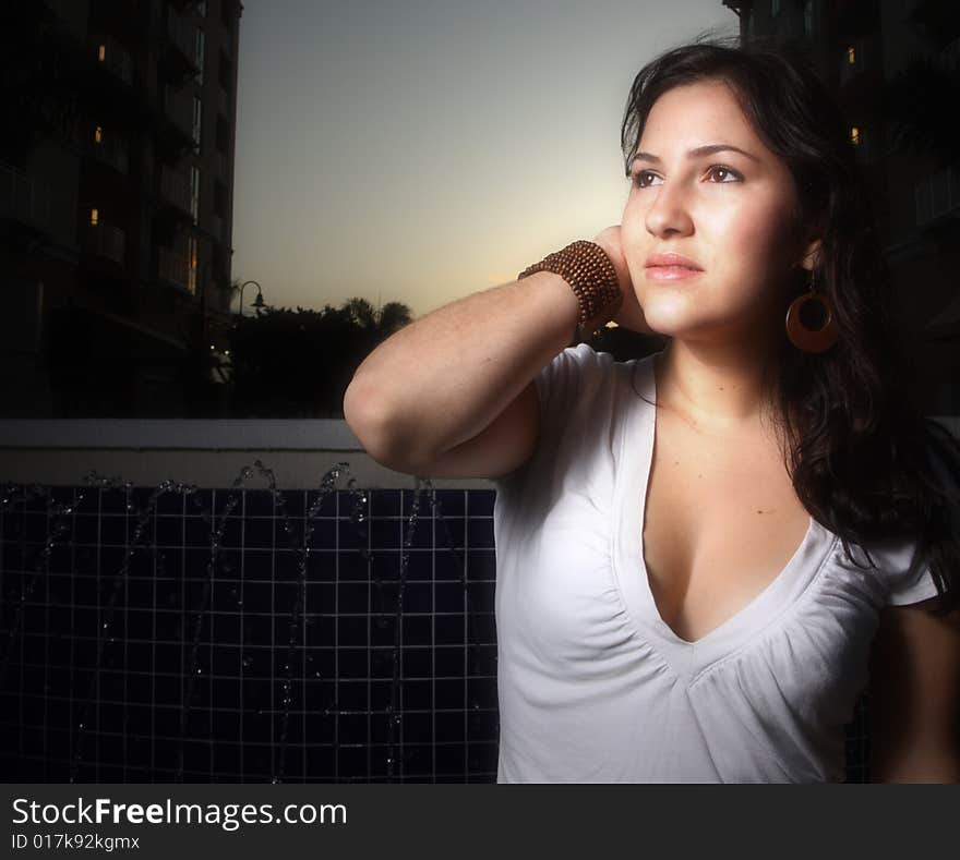 Young woman staring at a light in the distance. Young woman staring at a light in the distance.