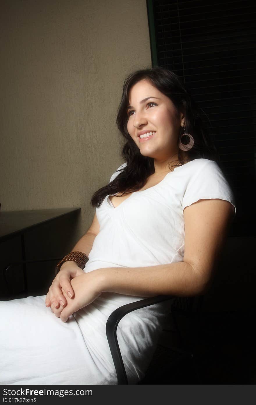 Woman sitting and smiling on a chair