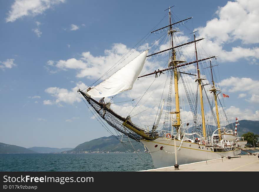 Sailboat on harbour. Old wooden sailboat on the sunny day.