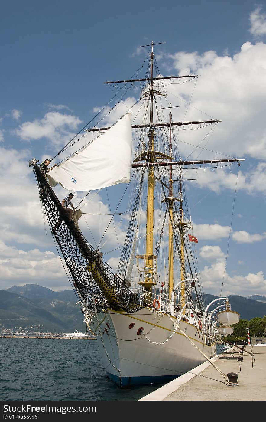 Sailboat on harbour. Old wooden sailboat on the sunny day.