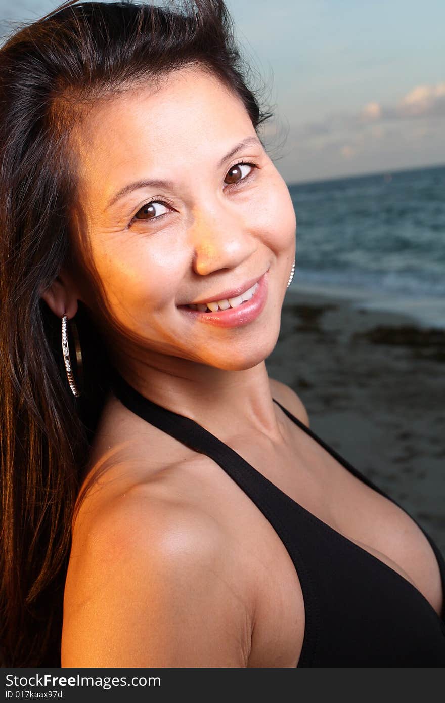 Young female smiling with a beautiful blue sky background. Young female smiling with a beautiful blue sky background