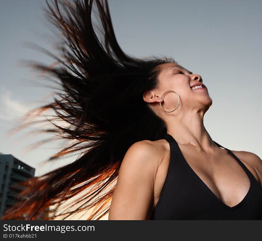 Woman in a bikini flinging her hair in the air. Woman in a bikini flinging her hair in the air.