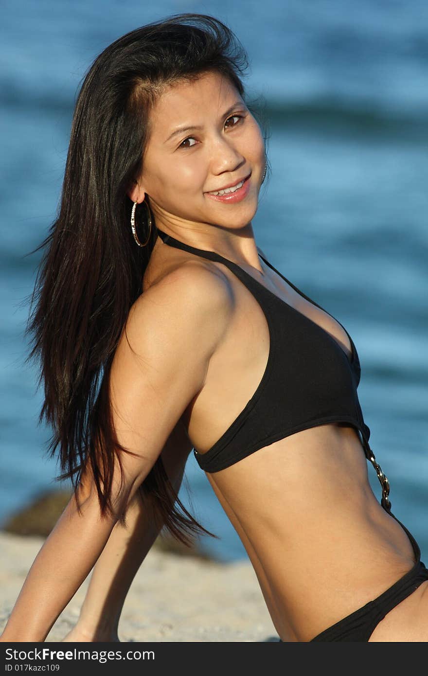 Woman looking over her shoulder on a blue water background. Woman looking over her shoulder on a blue water background.