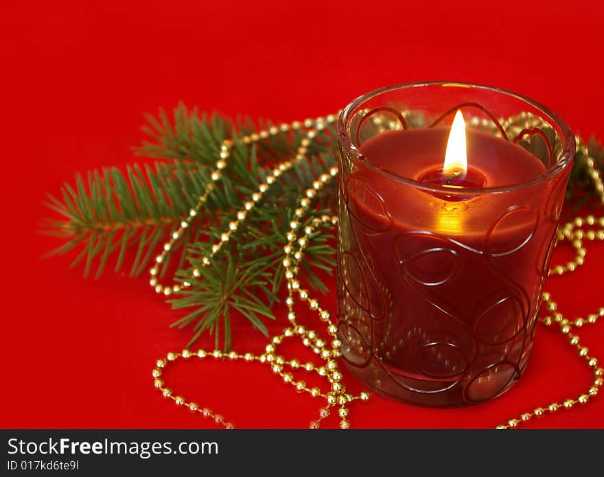 Candle and decoration on red