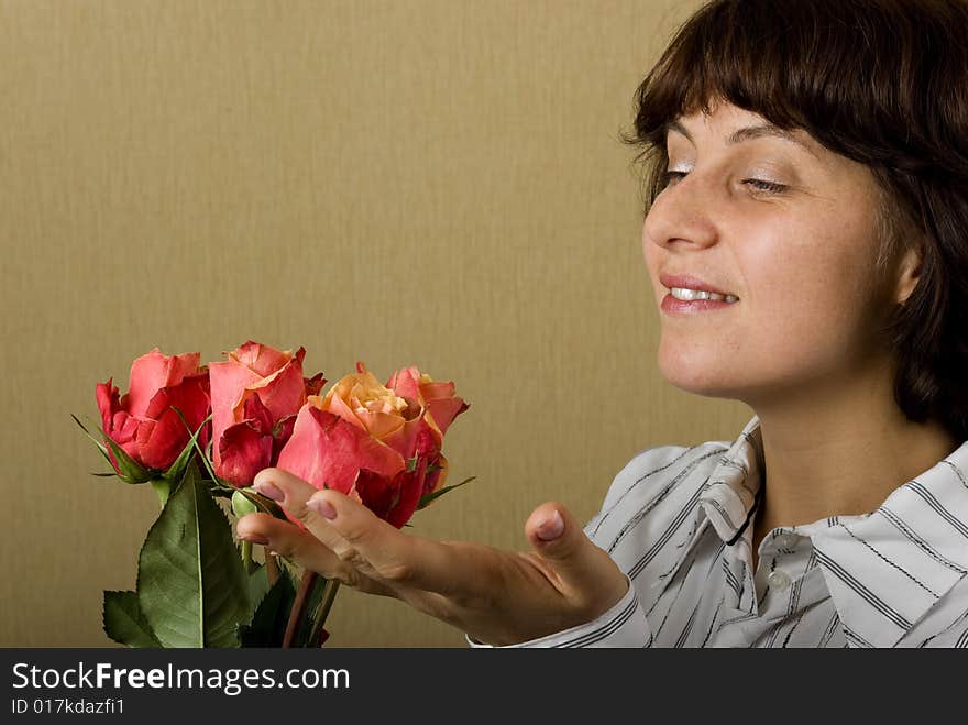 There is woman look on the flowers and smile. There is woman look on the flowers and smile