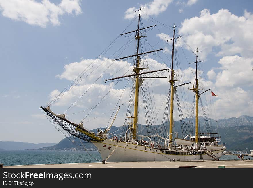 Sailboat on harbour. Old wooden sailboat on the sunny day.