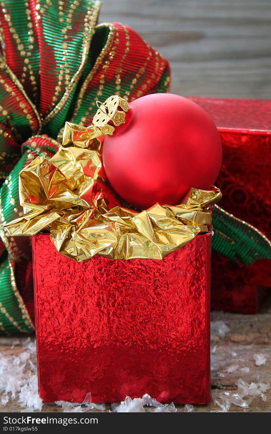 Christmas ornament on top of a red gift box.