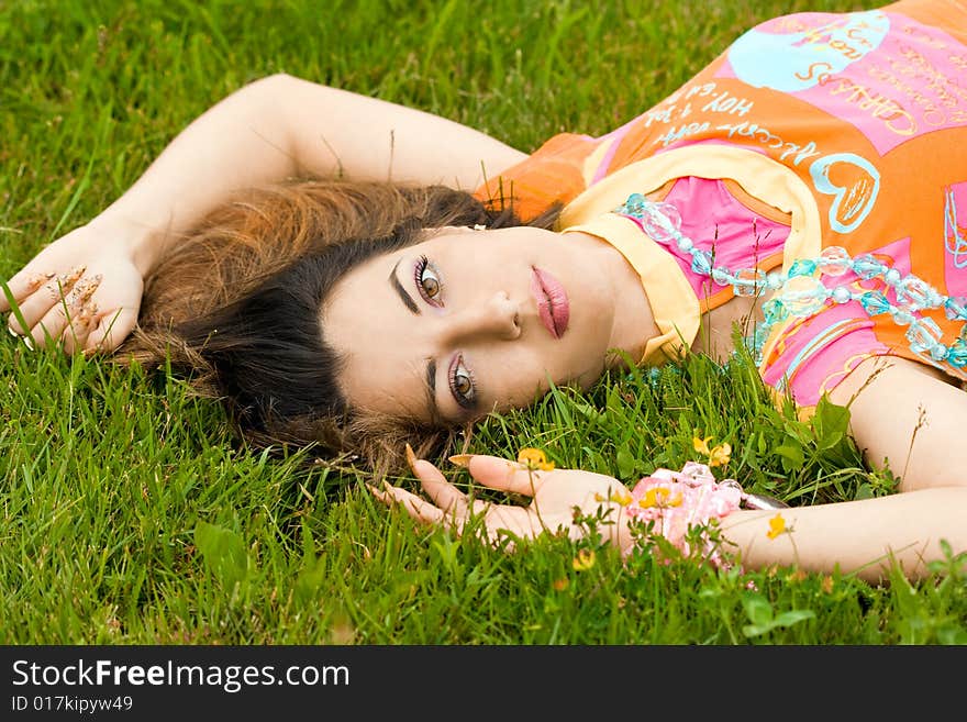 Woman Lies On A Grass