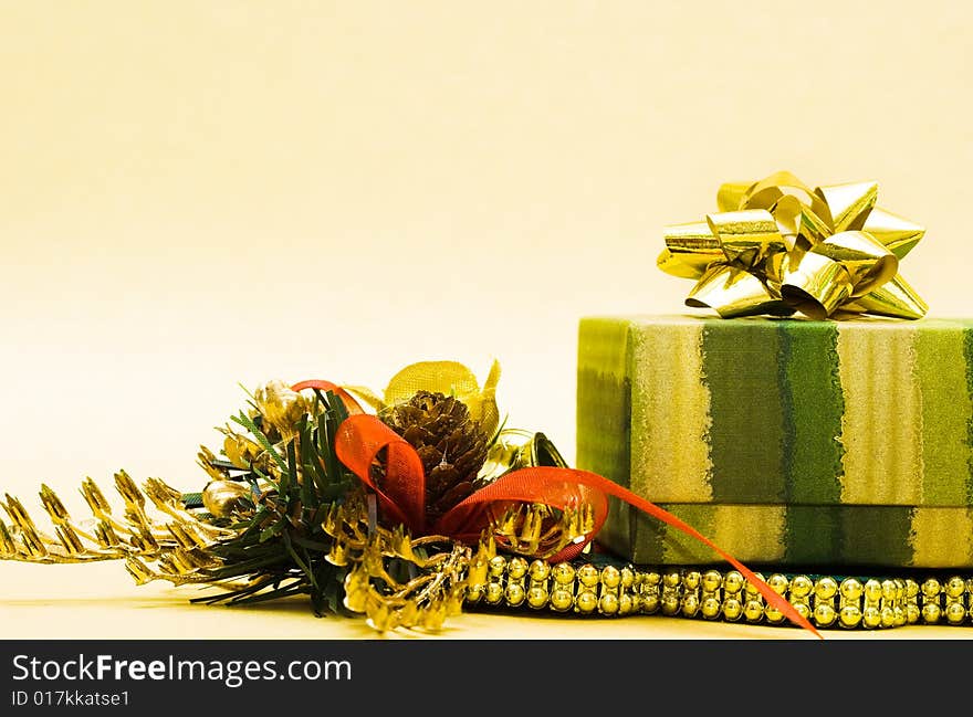 Christmas cone and gift box on yellow background