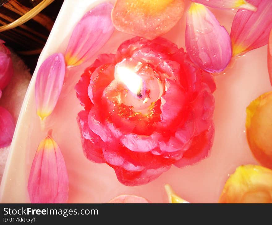 Spa essentials (candle on water and pink flowers)