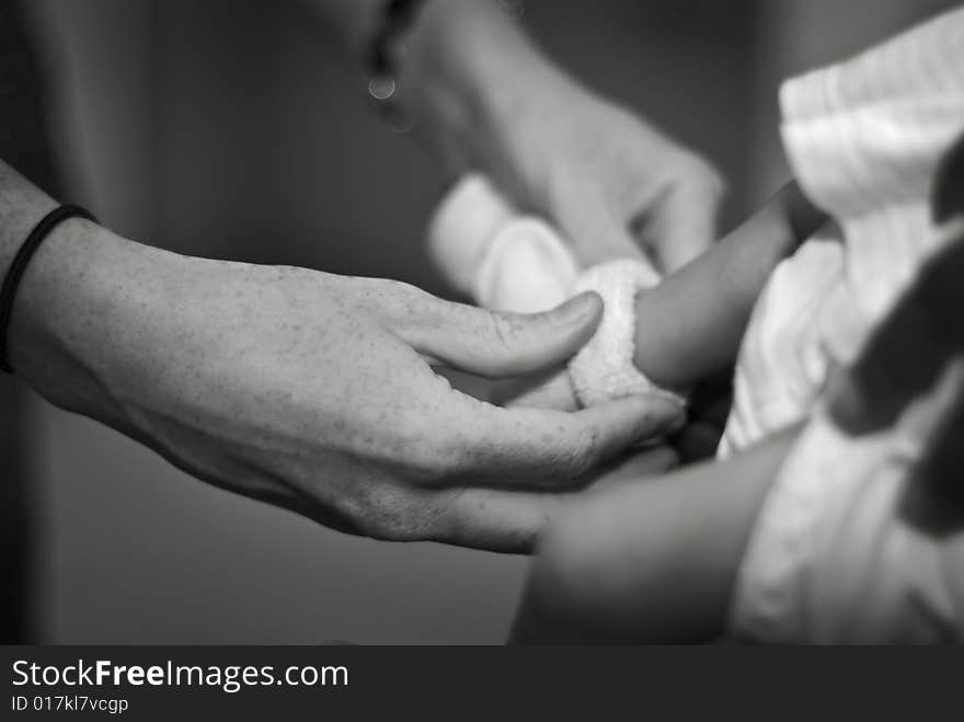 Mother Putting on baby s Sock