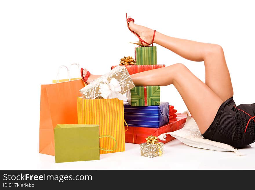 Attractive woman legs over many gift boxes and bags. Attractive woman legs over many gift boxes and bags.