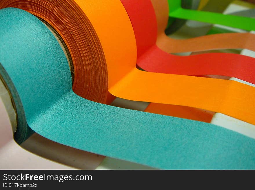 A Rainbow of colored medical/lab tape in a dispenser. A Rainbow of colored medical/lab tape in a dispenser.