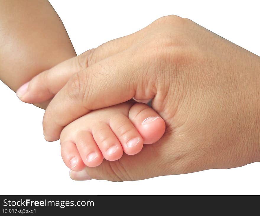 The little foot of daughter in the big hand of father. The little foot of daughter in the big hand of father