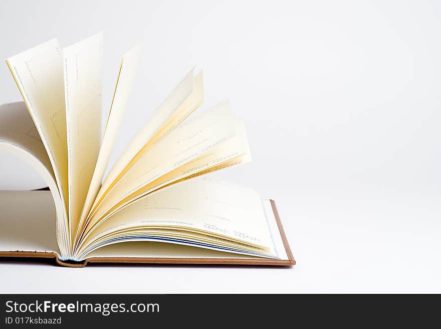 Open book with white sheets isolated over white