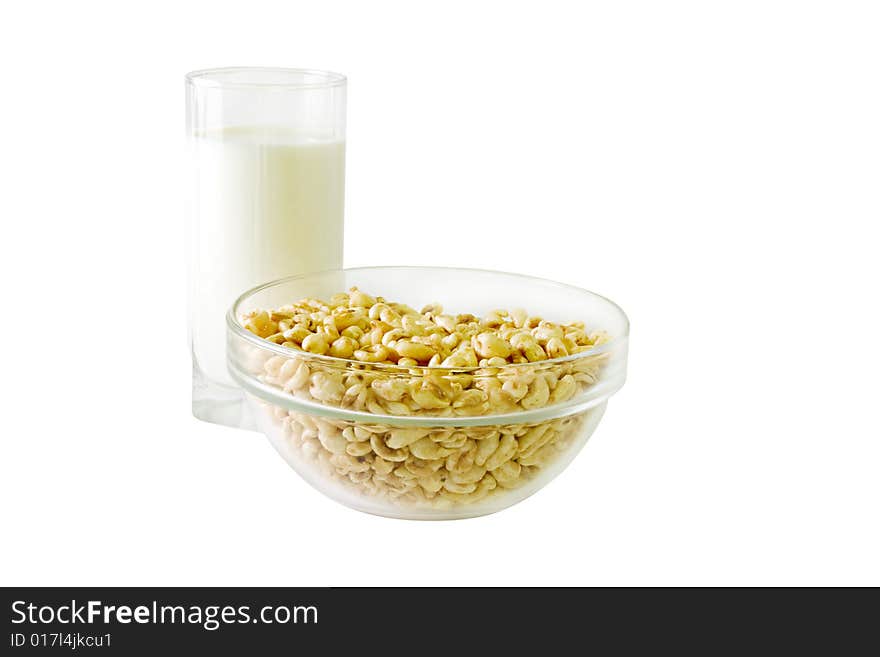 A glass of milk and a bowl of cereals. A glass of milk and a bowl of cereals