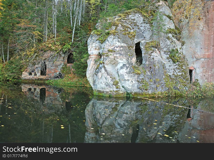 The stone cliff on the forest river. The stone cliff on the forest river.