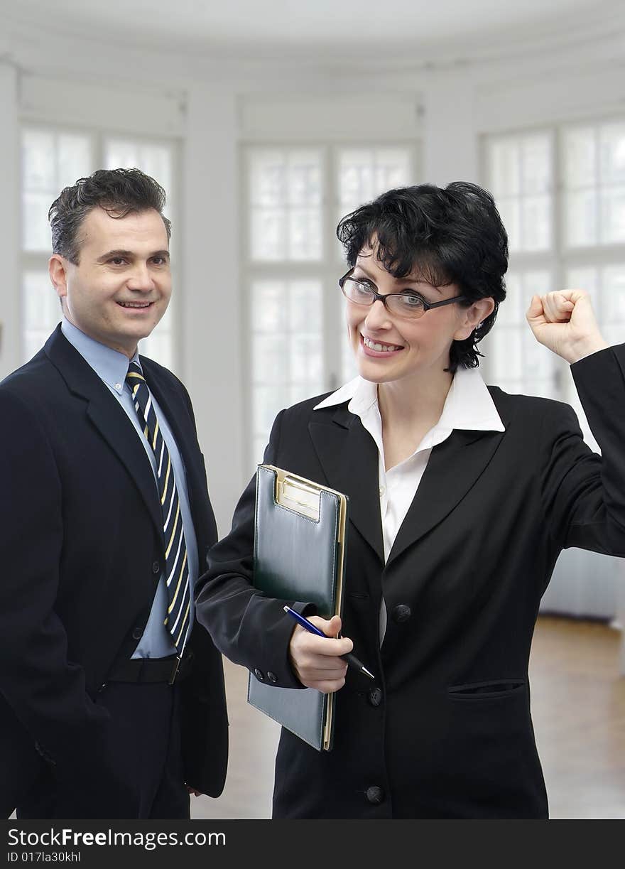 Young smiling businessman and a businesswoman. Young smiling businessman and a businesswoman