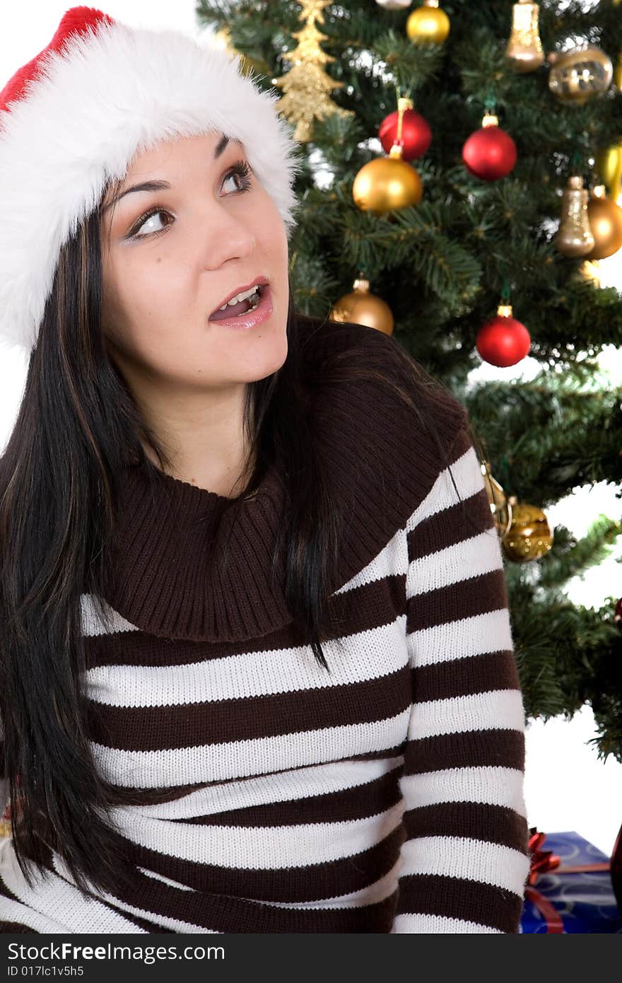 Attractive brunette woman happy over christmas tree. Attractive brunette woman happy over christmas tree