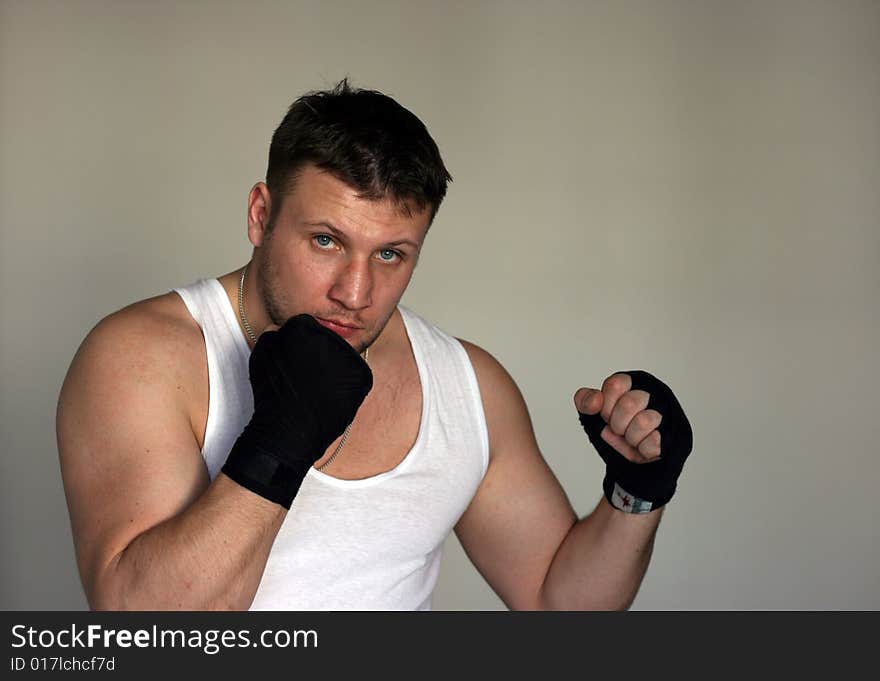 A young man with black fighting gloves and a bruise on the nose. A young man with black fighting gloves and a bruise on the nose