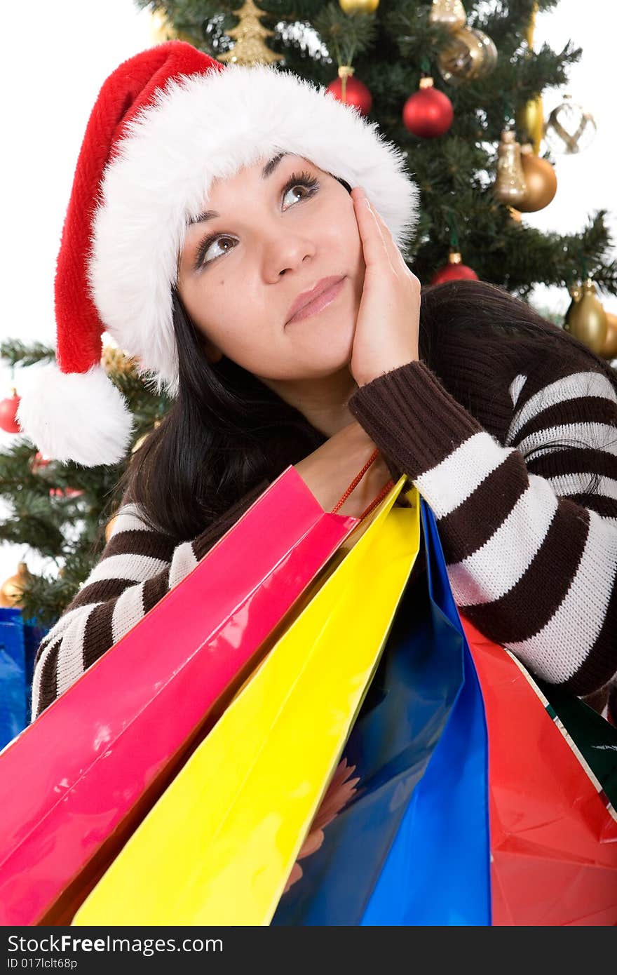 Attractive brunette woman happy over christmas tree. Attractive brunette woman happy over christmas tree