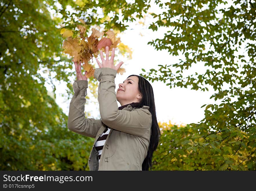 Attractive brunette woman relaxing in park. Attractive brunette woman relaxing in park