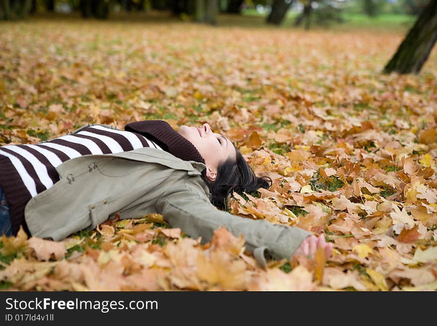 Attractive brunette woman relaxing in park. Attractive brunette woman relaxing in park