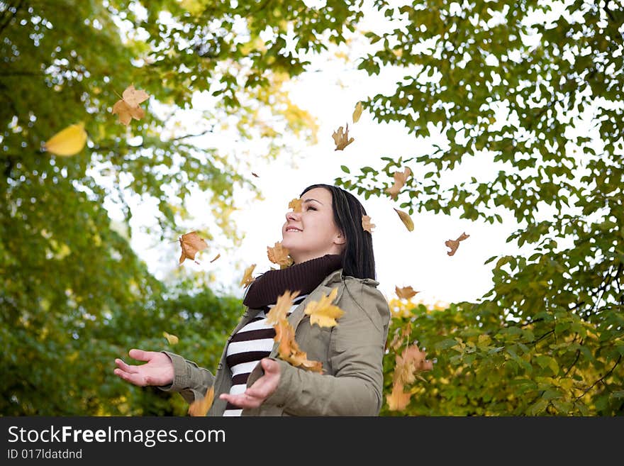 Attractive brunette woman relaxing in park. Attractive brunette woman relaxing in park