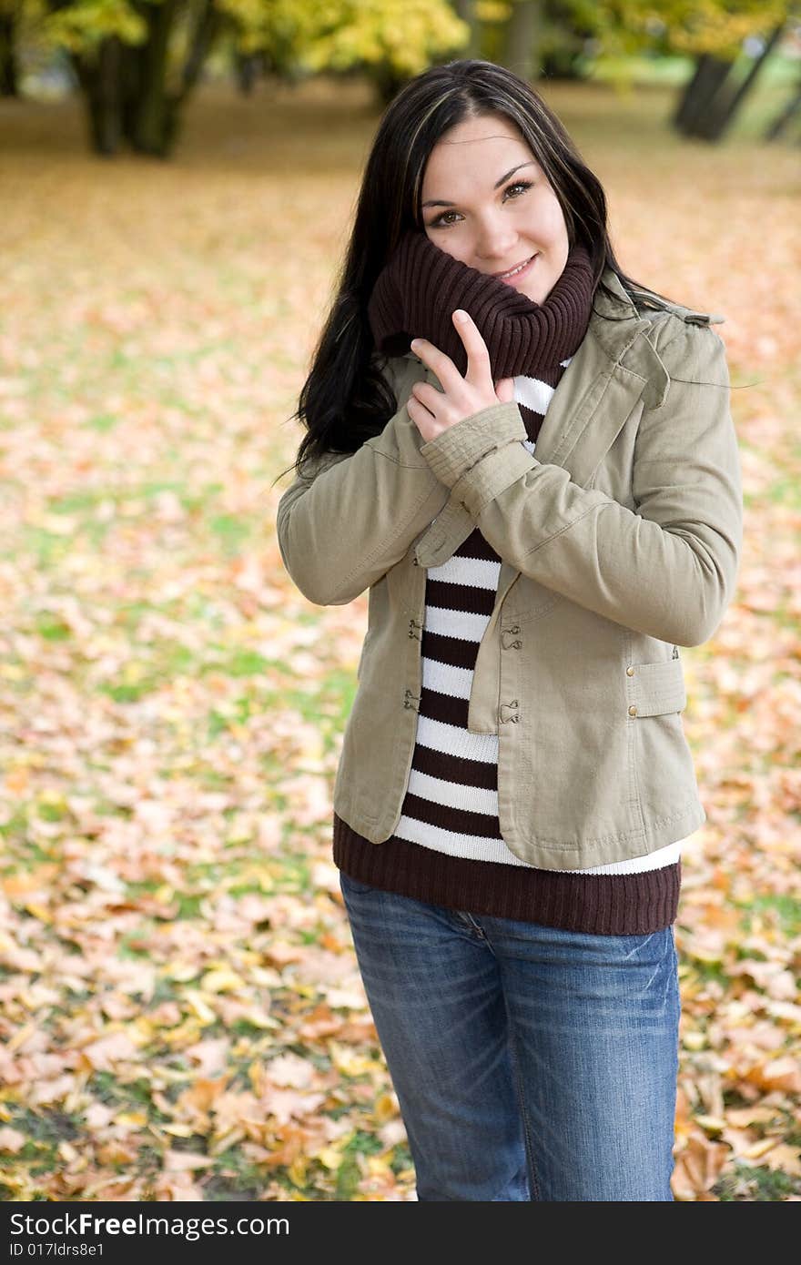 Attractive brunette woman relaxing in park. Attractive brunette woman relaxing in park