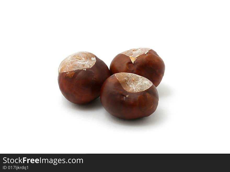 Three chestnuts isolated on white background