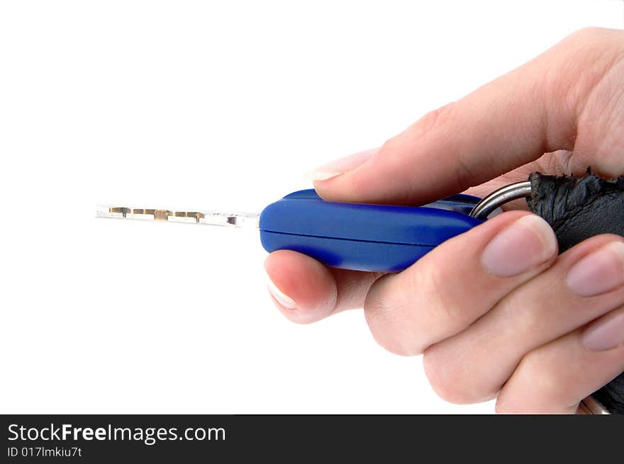 An isolated image of a hand pressing a button on a vehicle key fob. An isolated image of a hand pressing a button on a vehicle key fob