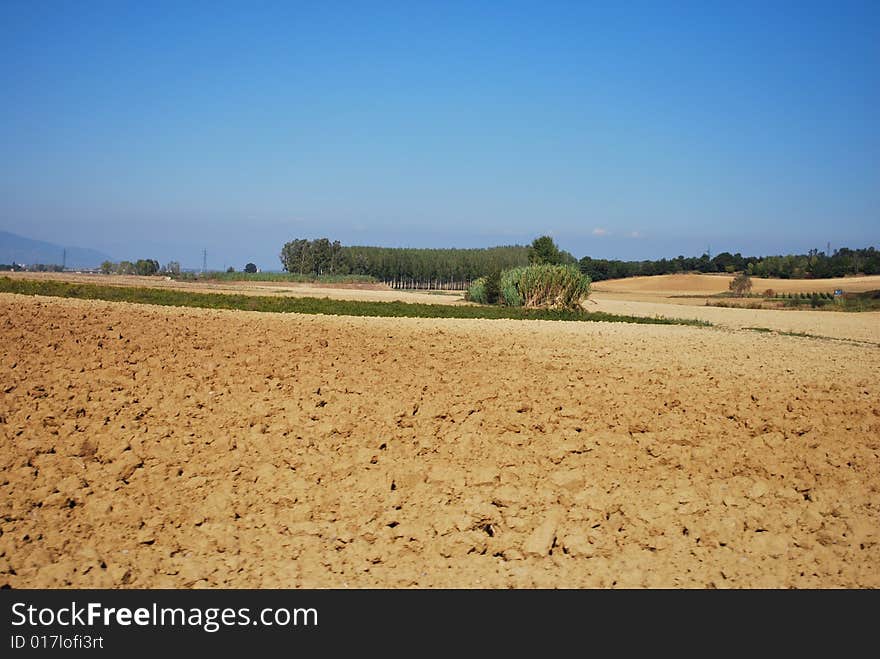 Barren farmland during winter with landscape background