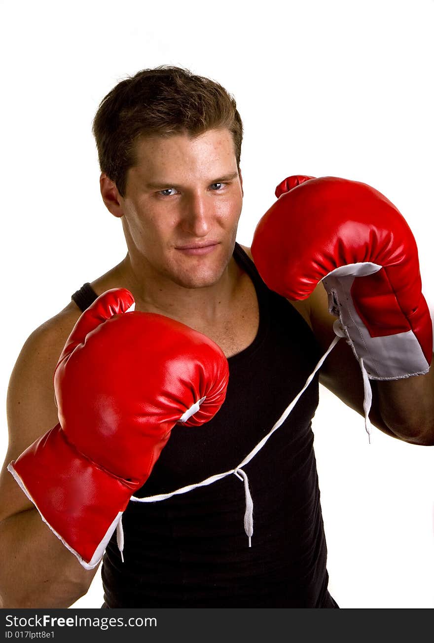 A boxer in workout clothes and red boxing gloves isolated on white. A boxer in workout clothes and red boxing gloves isolated on white