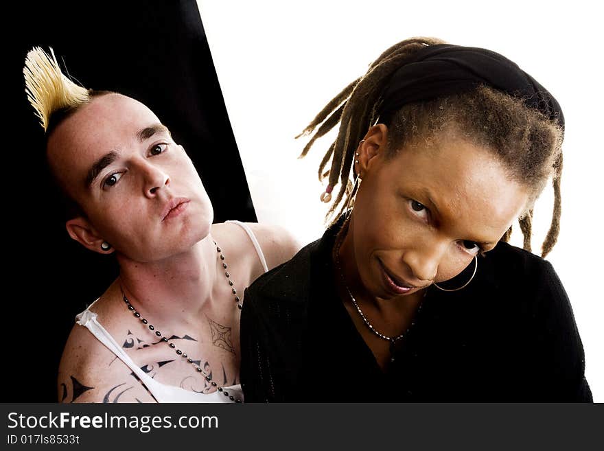 Portrait of white man with mohawk and black woman with dreadlocks. Portrait of white man with mohawk and black woman with dreadlocks