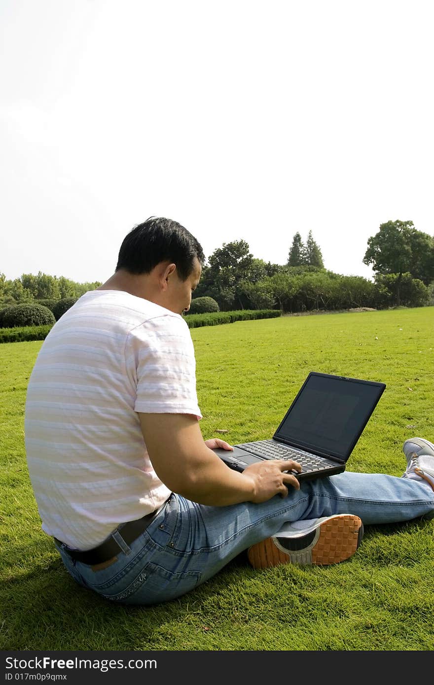 Man Using A Laptop Outdoors